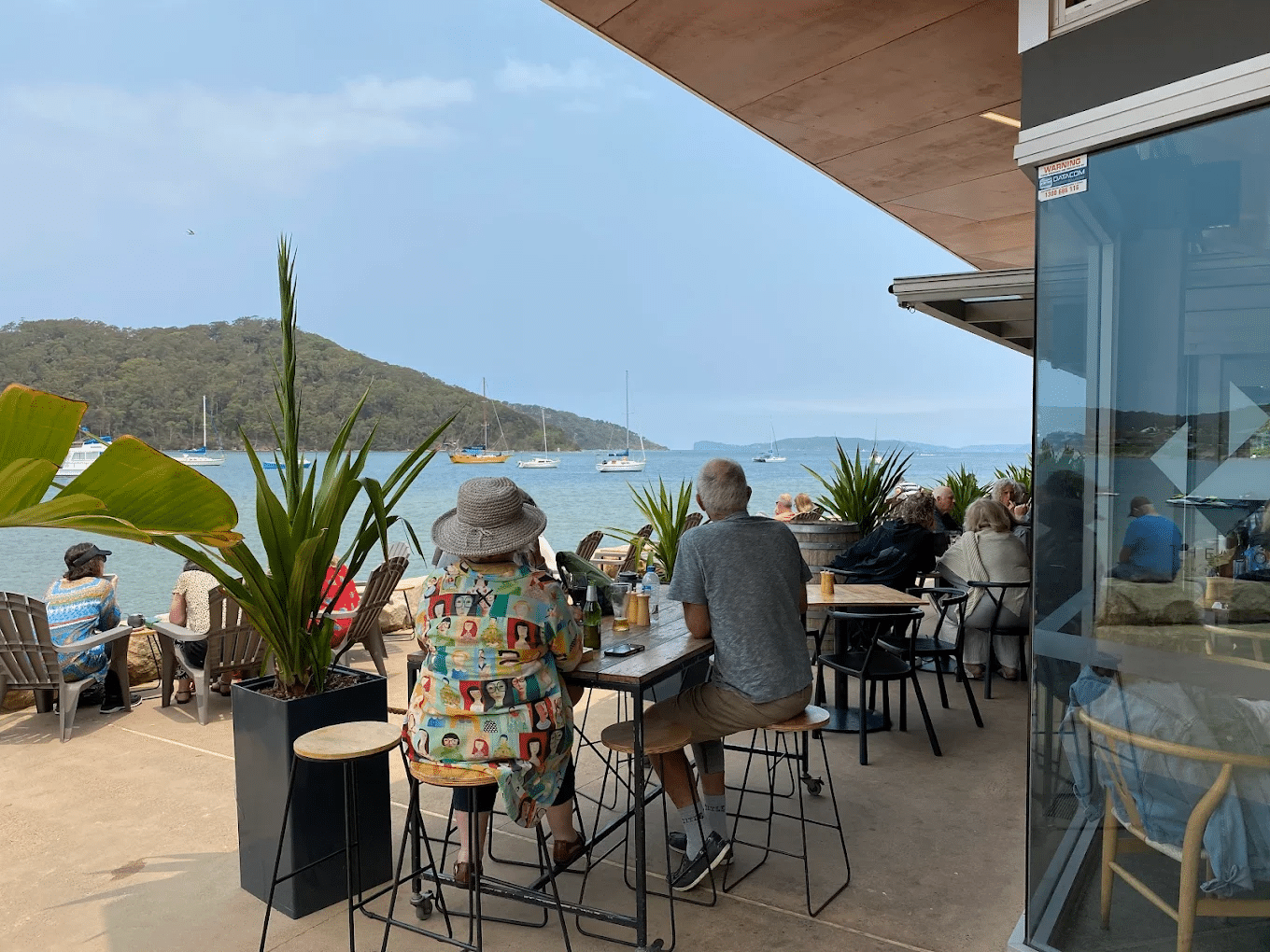 People dining at oceanfront table on Central Coast food tour