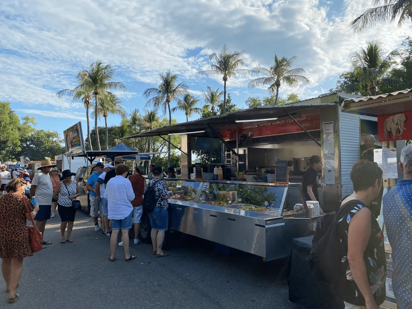 People gathering around a food cart on a food tour in Darwin