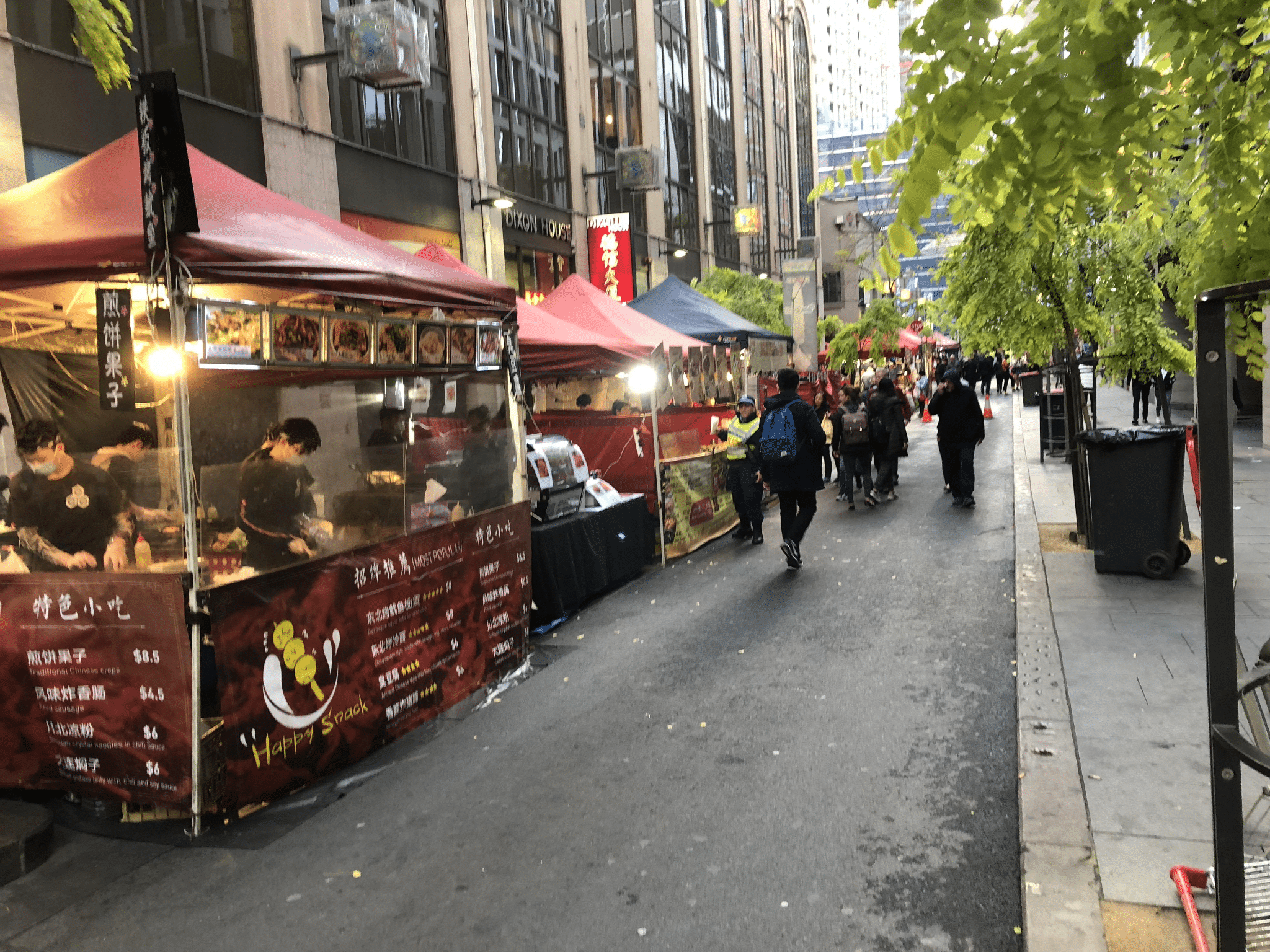 People walking near food cart in Sydney street during team-building event