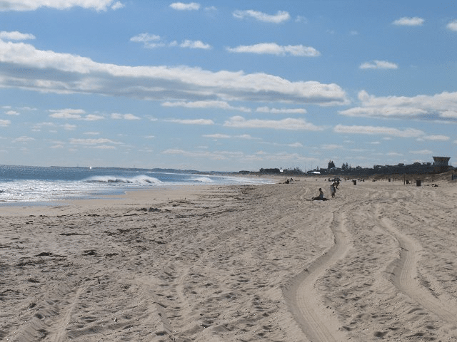 People walking on a sandy beach in Perth