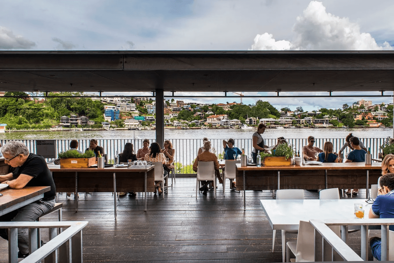 People working on laptops at tables during autumn in Brisbane