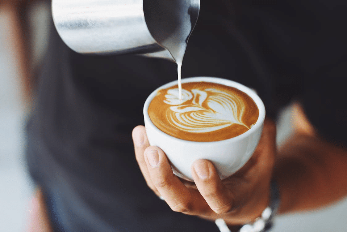 Person pouring coffee on a budget day trip from Perth
