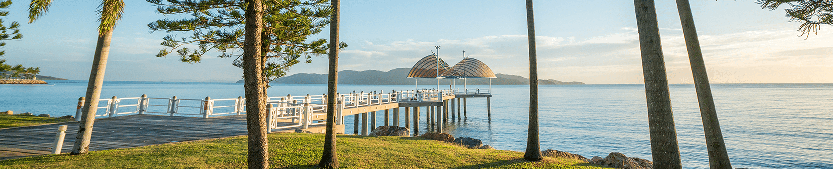Pier with palm trees and water in Townsville