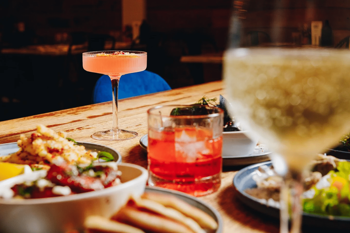 Platters of food and drinks on a wooden table