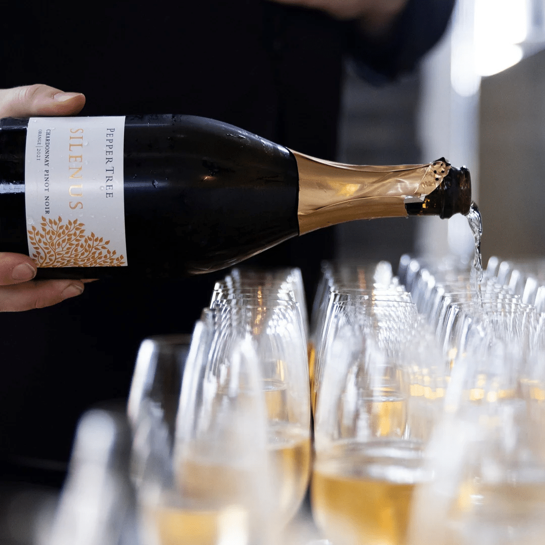 Pouring champagne into glasses at Pepper Tree Wine