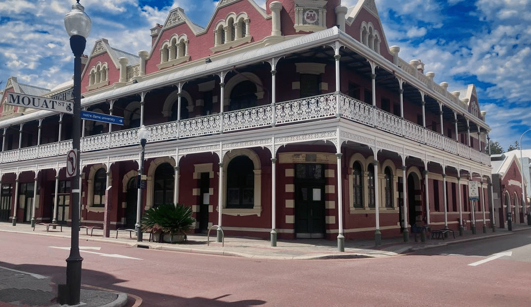 Red and white building on a street corner in Perth