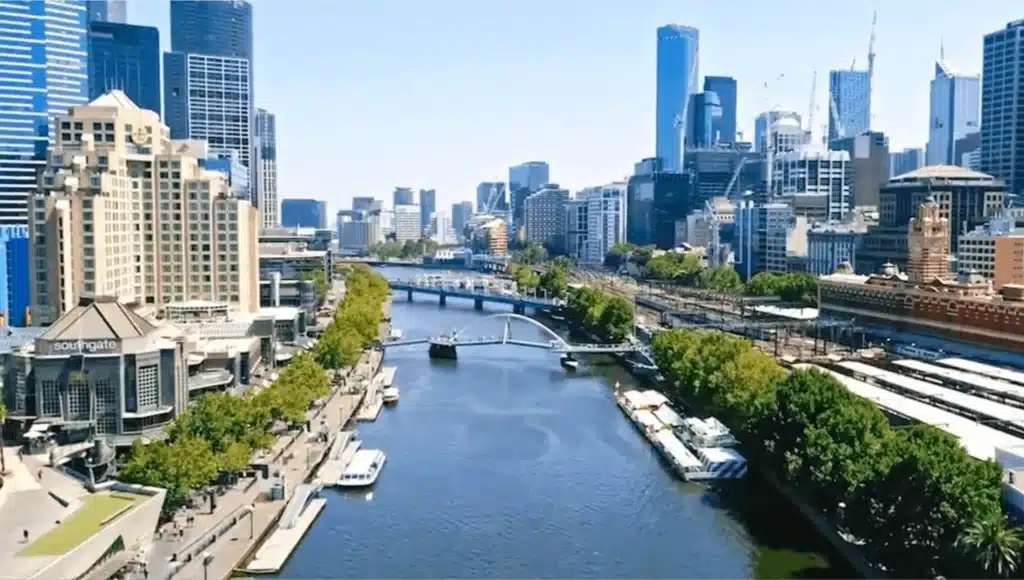 River flowing through Melbourne cityscape with tall buildings