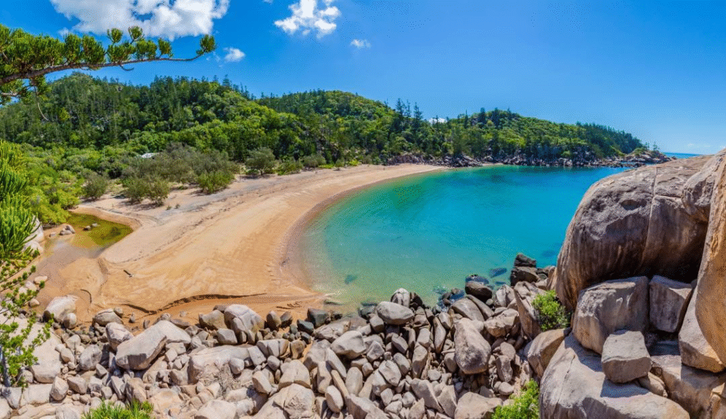 Sandy beach with rocks and trees in Townsville