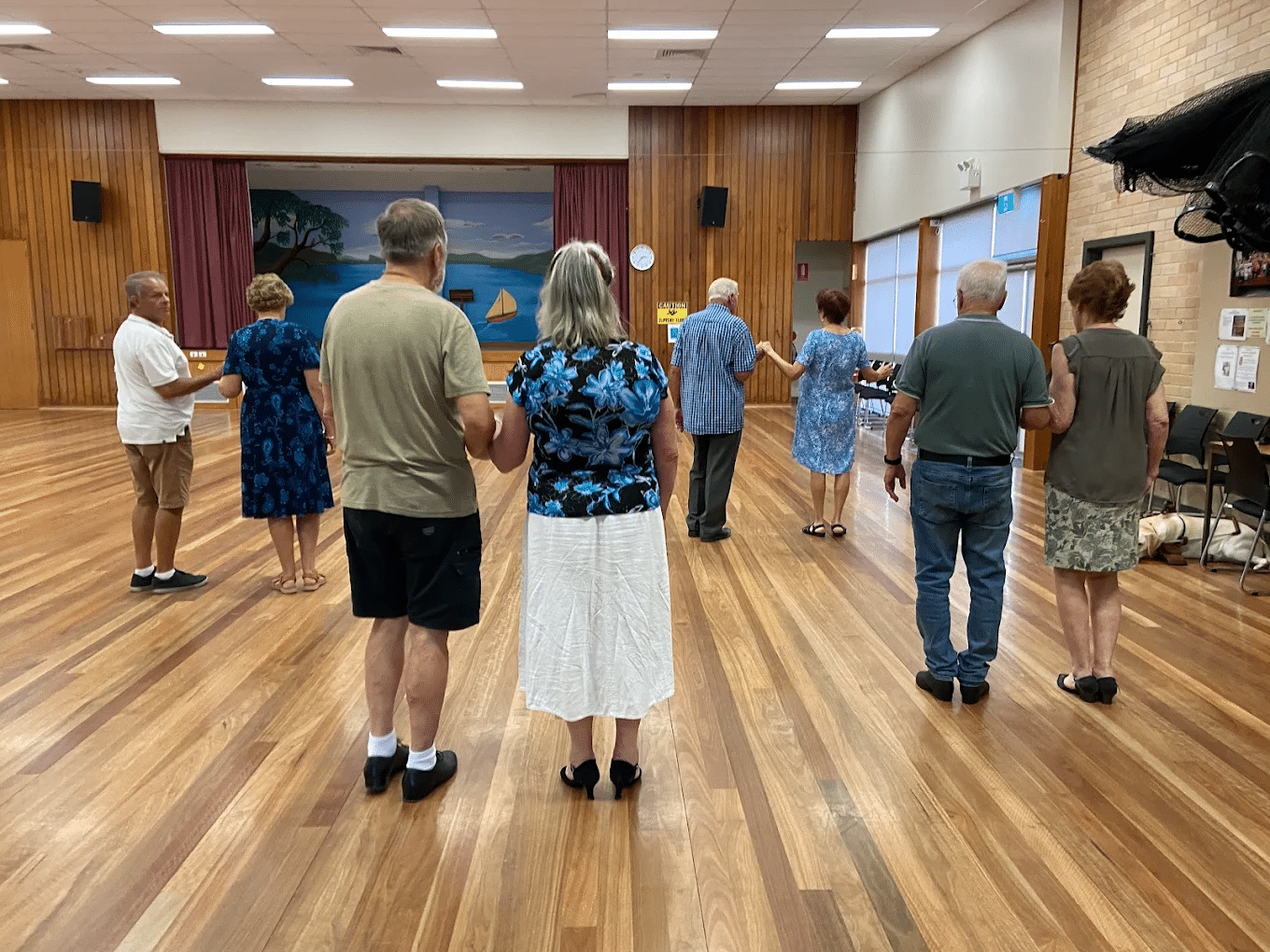Senior citizens group standing on hardwood floor