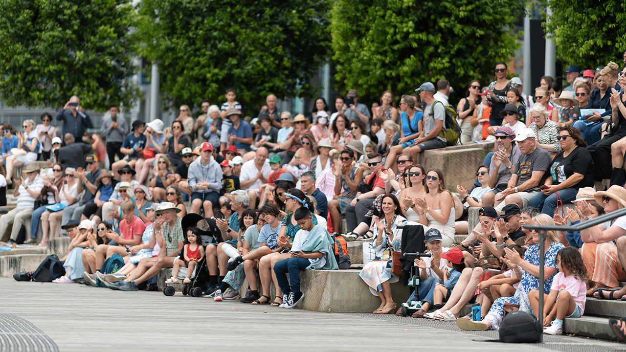 Skateboarder performing trick in front of audience