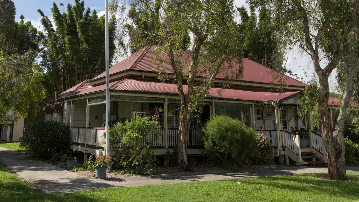 Small red-roofed house surrounded by trees at Sunshine Coast