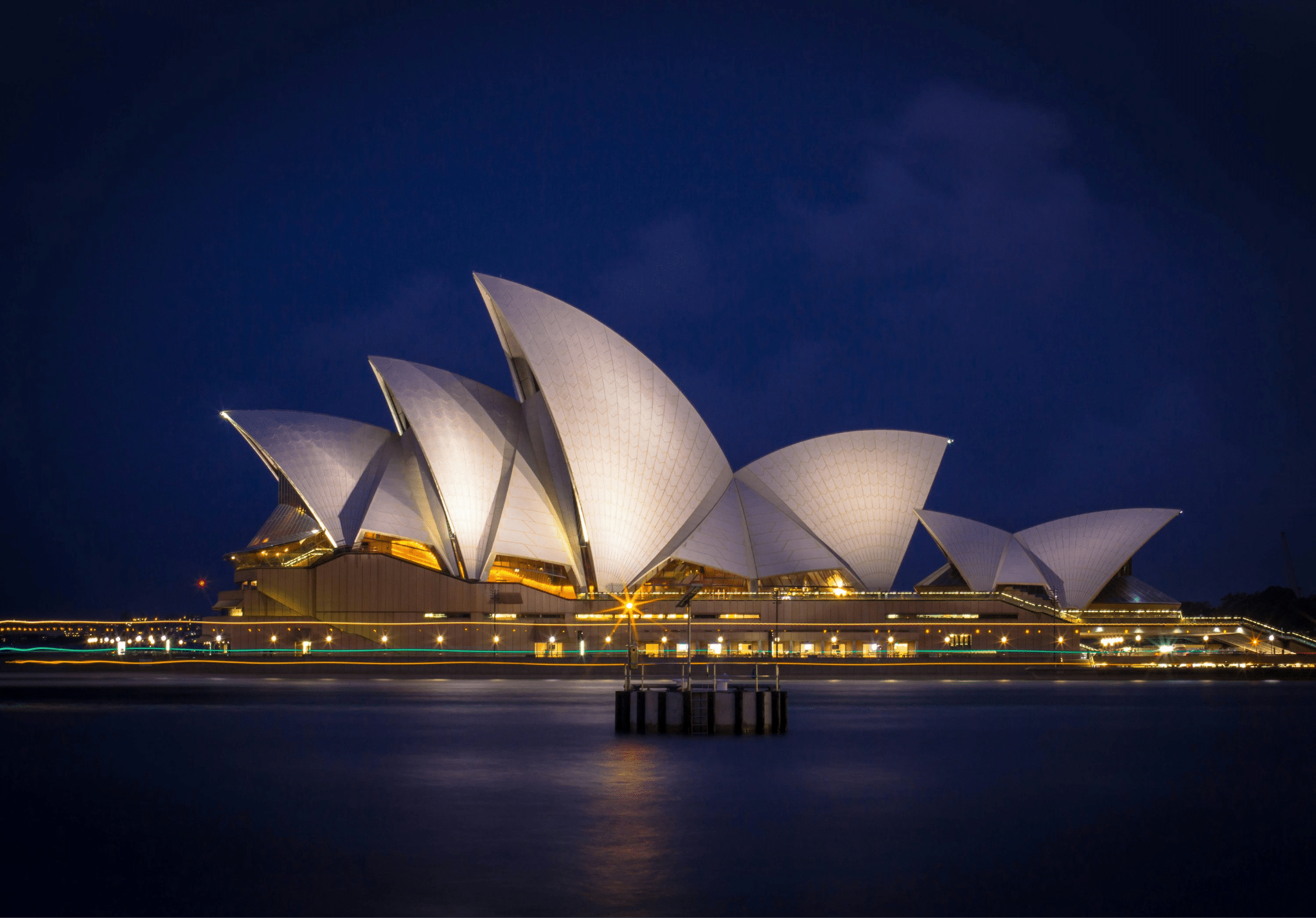 Sydney opera house illuminated at night during luxury experience
