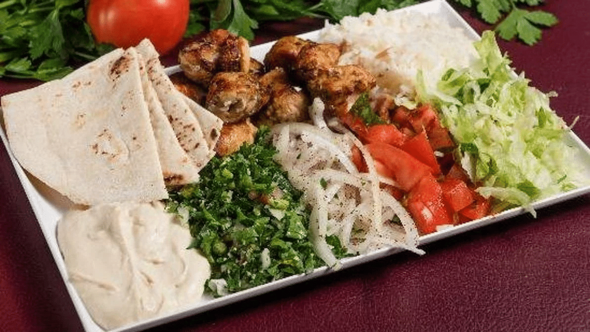 Tacos with vegetables on a white plate