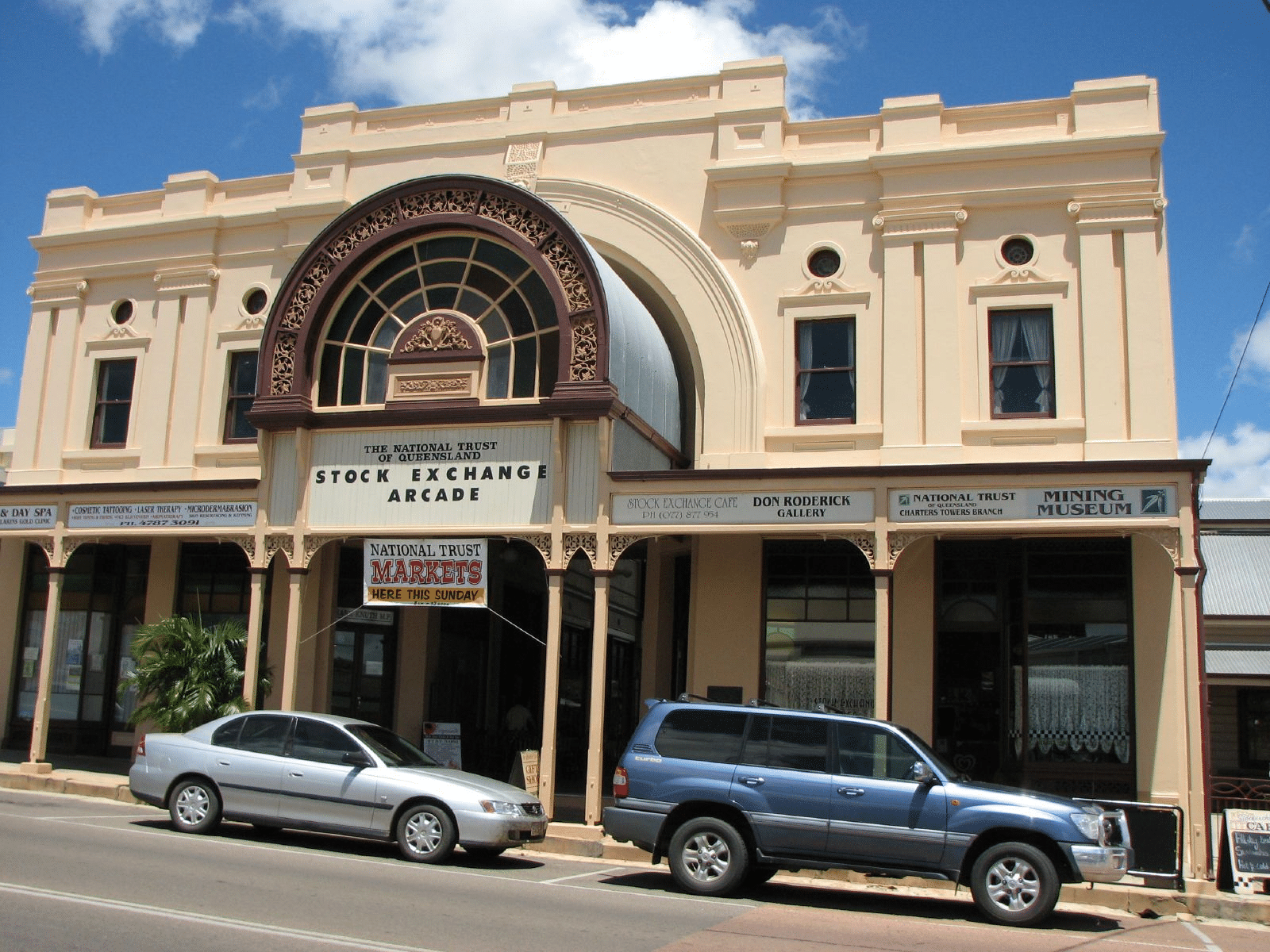 Two cars in front of a Townsville building