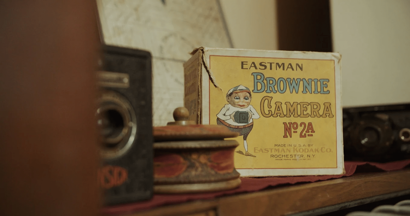 Vintage brownie camera on wooden shelf