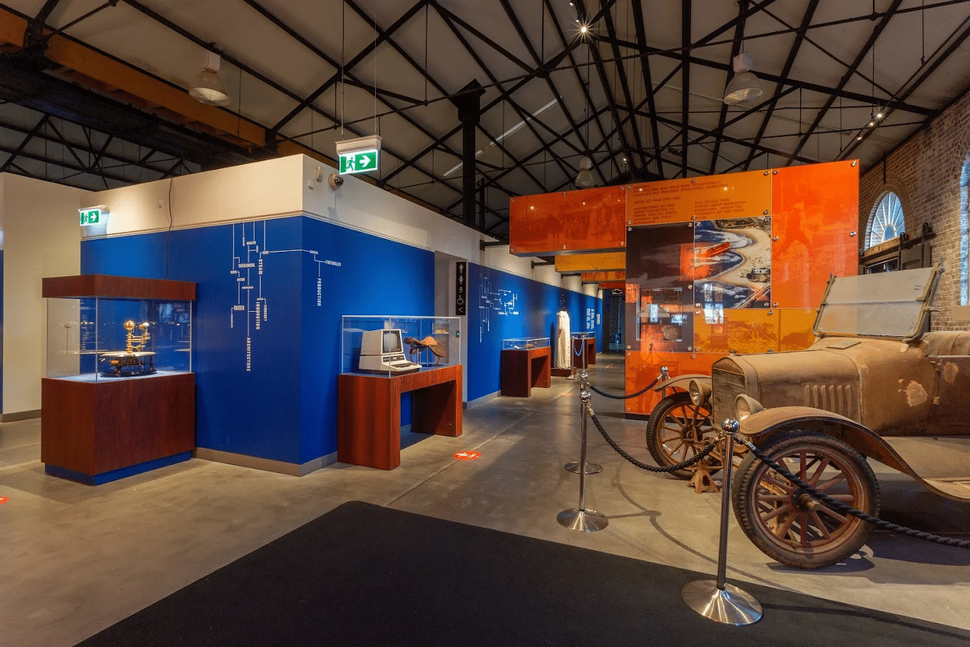 Vintage cars displayed in a museum for school excursions