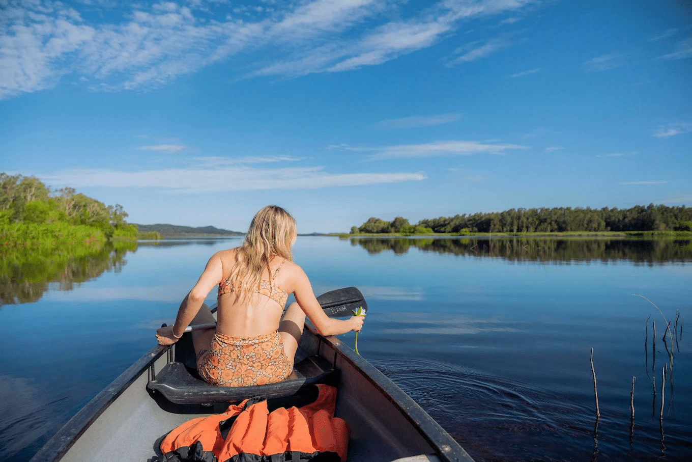 Woman enjoying lake boat ride in Sunshine Coast