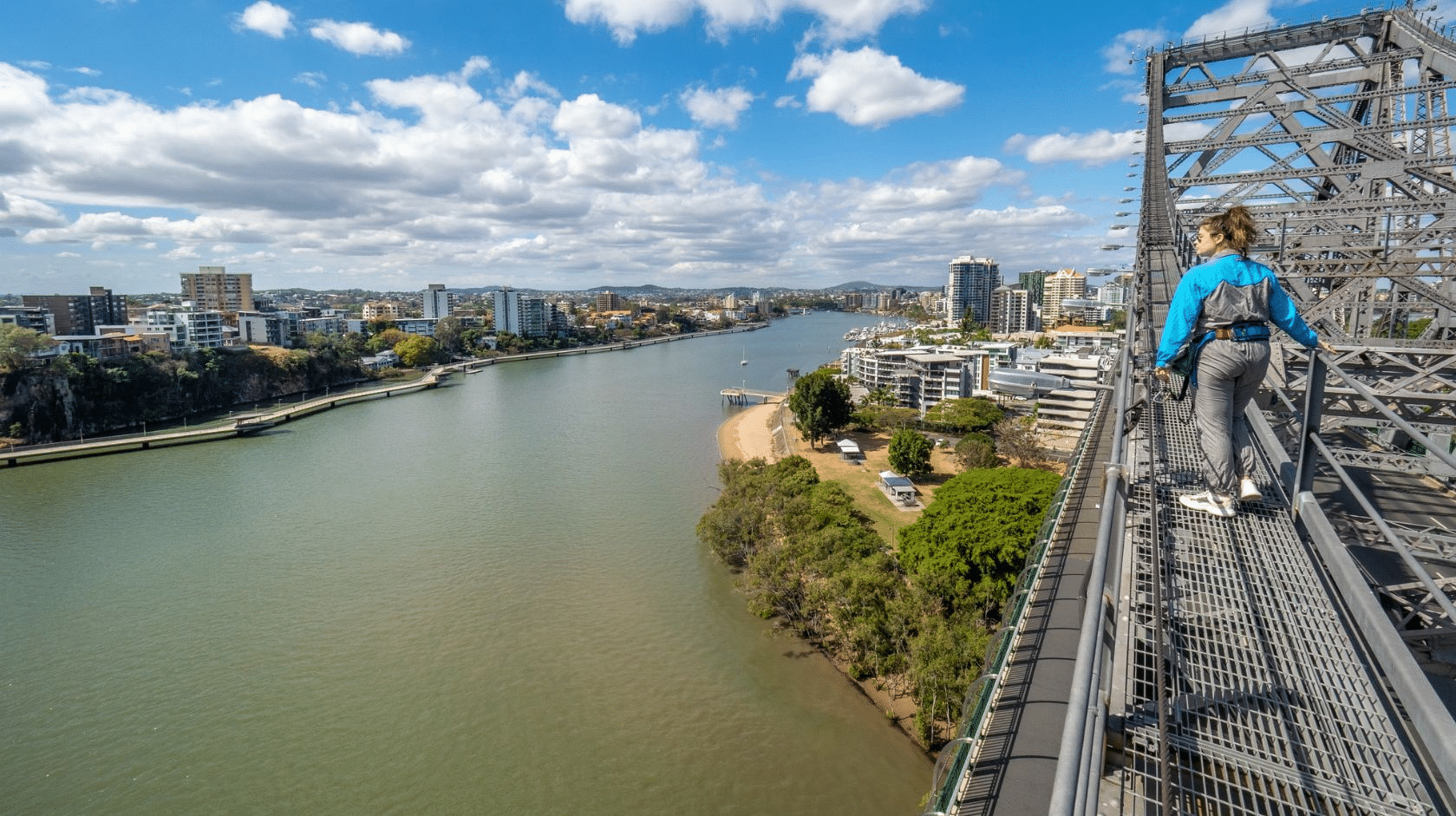 Woman walking on a bridge over a river in Brisbane