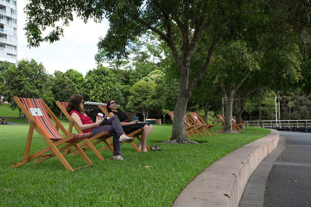 Women sitting on lawn chairs in Roma Street Parkland