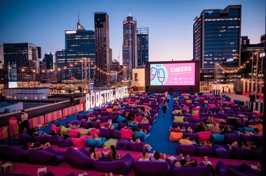 Young adults watching a movie on bean bags in Perth