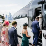 Group in race-day outfits boarding a BusCharter coach for the Melbourne Cup